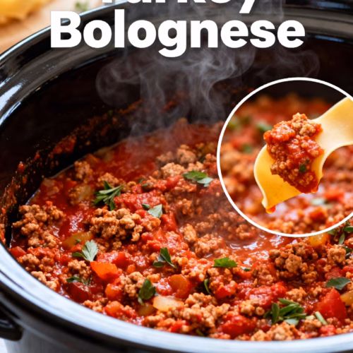 image of flat lay of fresh ingredients for turkey bolognese including ground turkey canned tomatoes onions garlic carrots celery herbs and pasta