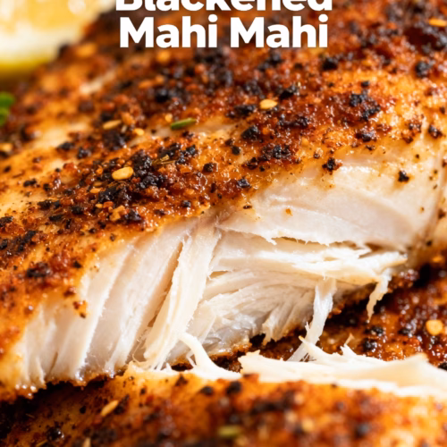 image of a flat lay of ingredients for Air Fryer Blackened Mahi Mahi including mahi mahi fillets blackened seasoning lemon wedges olive oil and fresh parsley on a rustic wooden board with a bright background