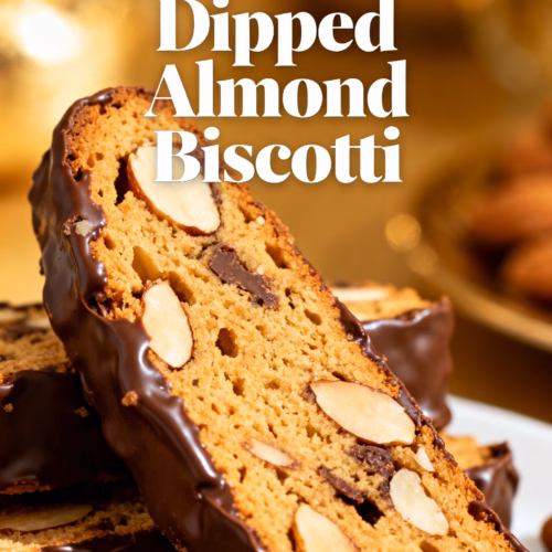 image of close up top down shot of a collection of fresh ingredients used for baking Chocolate Dipped Almond Biscotti including flour sugar eggs almonds cocoa powder chocolate chips and vanilla extract all arranged artfully on a rustic wooden surface with soft natural light