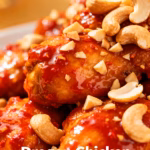 image of realistic top down mise en place shot of fresh ingredients for dragon chicken arranged on white marble kitchen counter with healthy clear glass bowls and rustic brown wooden kitchen sets under soft diffuse daylight boneless chicken thighs red chili paste soy sauce oyster sauce cashews bell peppers white onion garlic ginger egg flour cornstarch sesame oil chinese black vinegar ketchup honey high smoke point oil spring onions sesame seeds