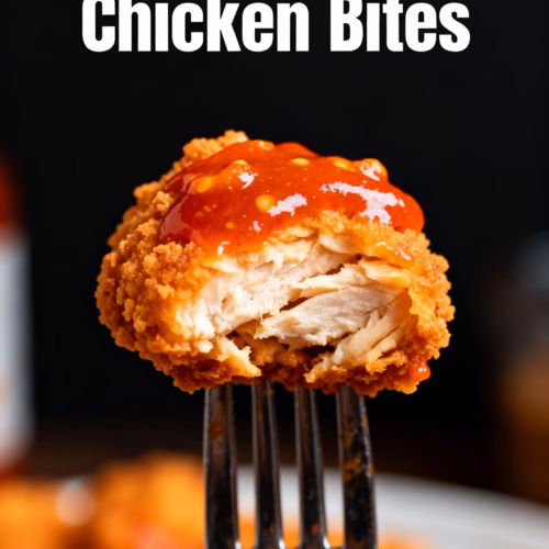 ingredients image of a visually appealing flat lay of fresh raw chicken breast cut into bite sized pieces measuring spoons and fresh garlic cloves with bottles of buffalo sauce and olive oil a bowl of cornstarch blue cheese crumbles chopped celery and fresh parsley ready for making delicious air fryer buffalo chicken bites