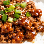 image of fresh ground beef in clear bowl low sodium soy sauce in glass bottle fresh garlic cloves fresh ginger root toasted sesame oil brown sugar in bowl honey jar white rice grains green onions red pepper flakes gochujang paste chili garlic sauce rice vinegar cooking oil salt pepper fried egg kimchi sesame seeds carrots cucumber spinach avocado arranged on white marble countertop with rustic brown wooden bowls and kitchen tools under soft natural daylight