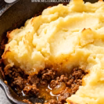 image of fresh ground lamb ground beef russet potatoes yukon gold potatoes onion carrots peas garlic butter milk cream beef stock tomato paste flour worcestershire sauce salt black pepper arranged on white marble counter with clear glass bowls and rustic brown wooden kitchen sets under soft diffuse daylight