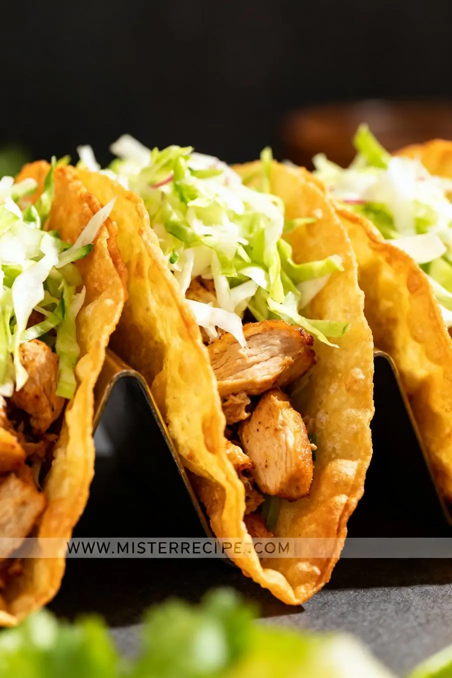 image of a top down mise en place shot showing shredded chicken breast wonton wrappers soy sauce hoisin sauce sesame oil garlic ginger coleslaw mix cabbage green onions carrots cilantro sesame seeds sweet chili sauce sriracha all arranged on a white marble kitchen counter with healthy clear glass bowls and rustic brown wooden kitchen sets under soft diffuse daylight